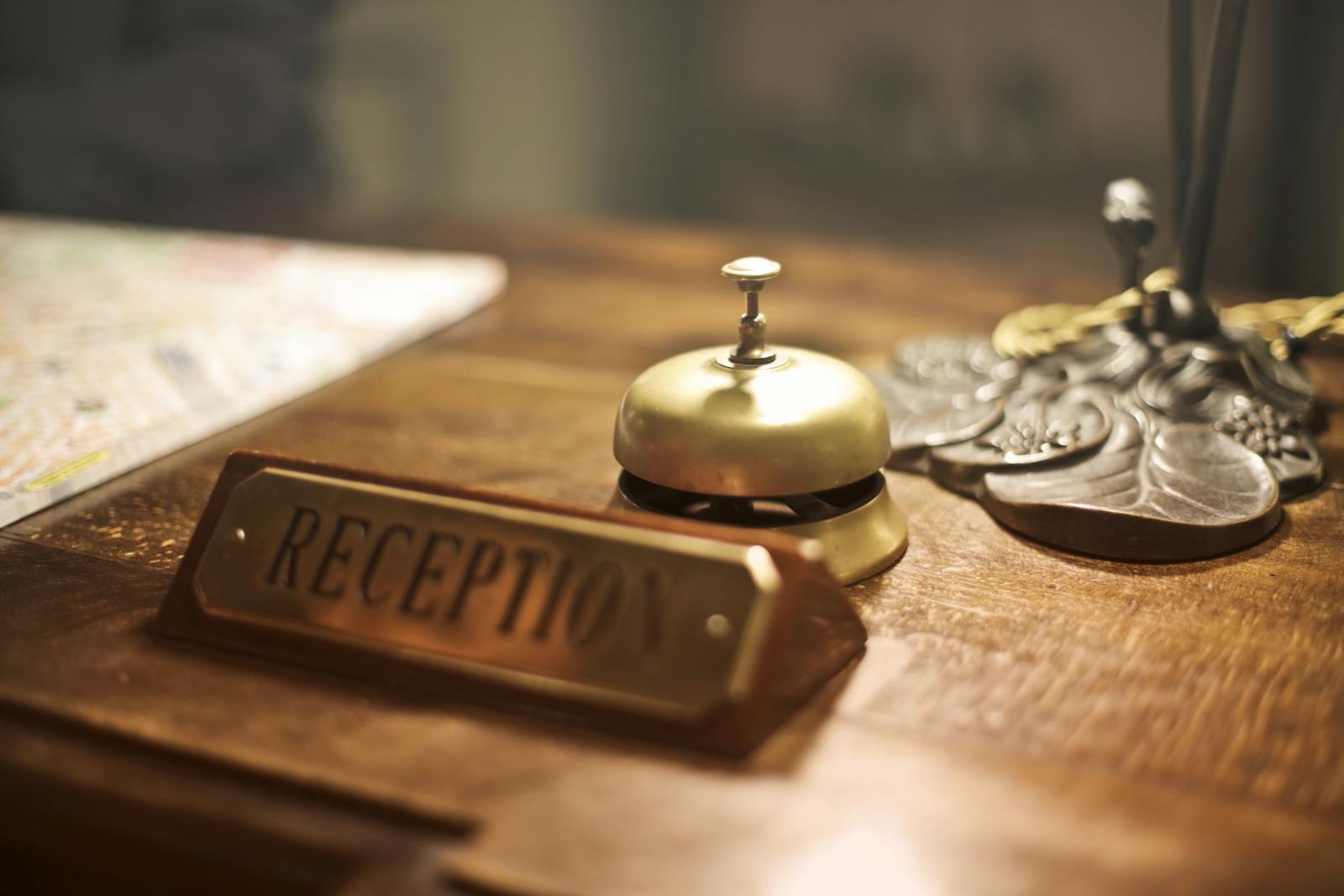 Metal bell and a placard that reads "Reception"