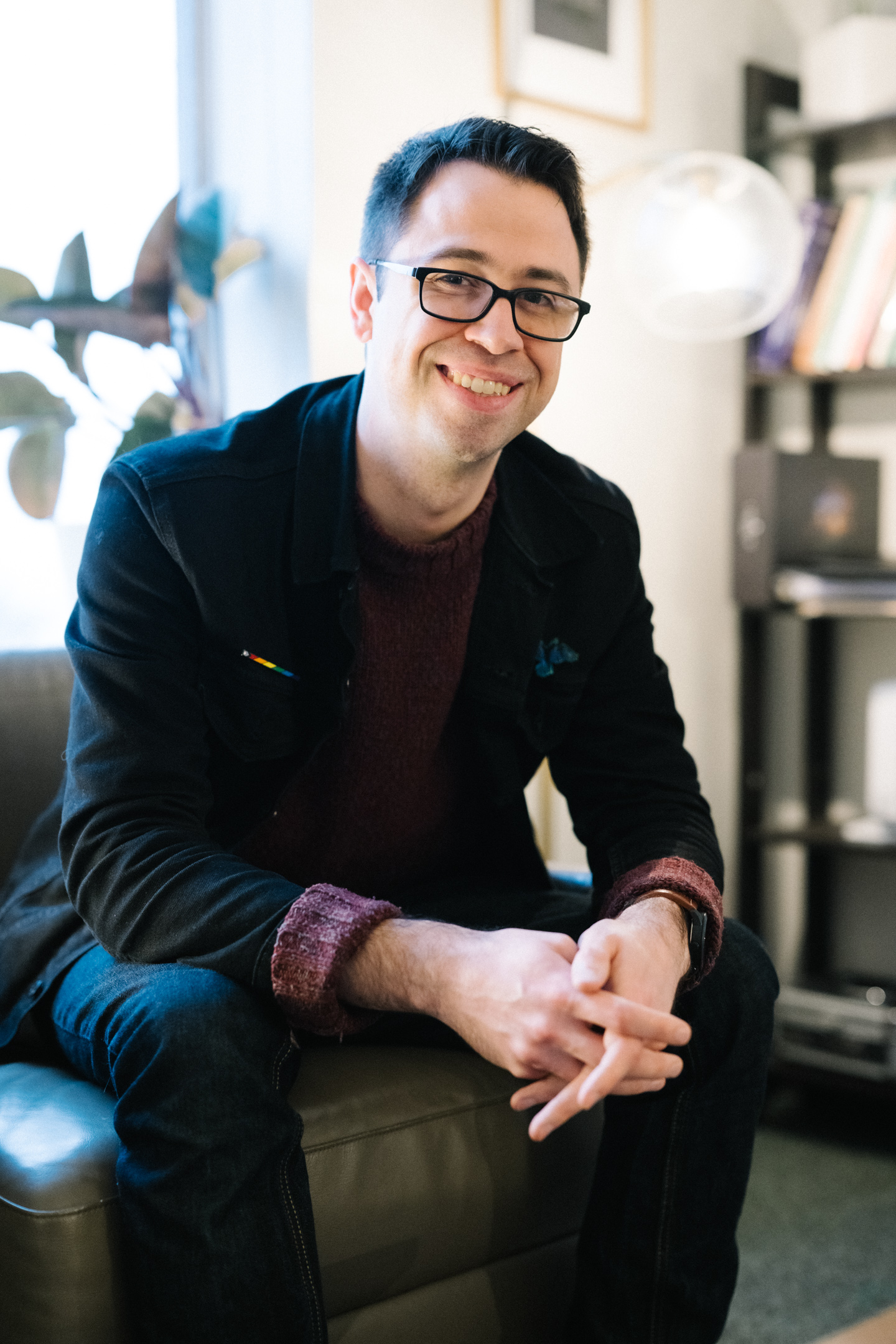 Spencer Wharton, a white counselor, smiles warmly at the camera, his hands folded.
